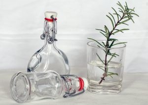 thyme in glass with bottles