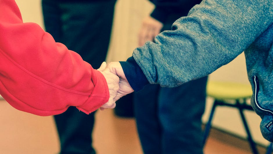 elderly couple holding hands