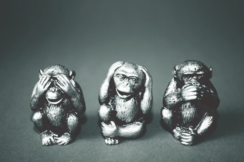 statuettes of monkeys displaying see no evil, hear no evil, speak no evil