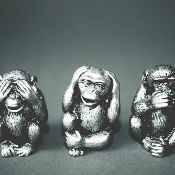 statuettes of monkeys displaying see no evil, hear no evil, speak no evil