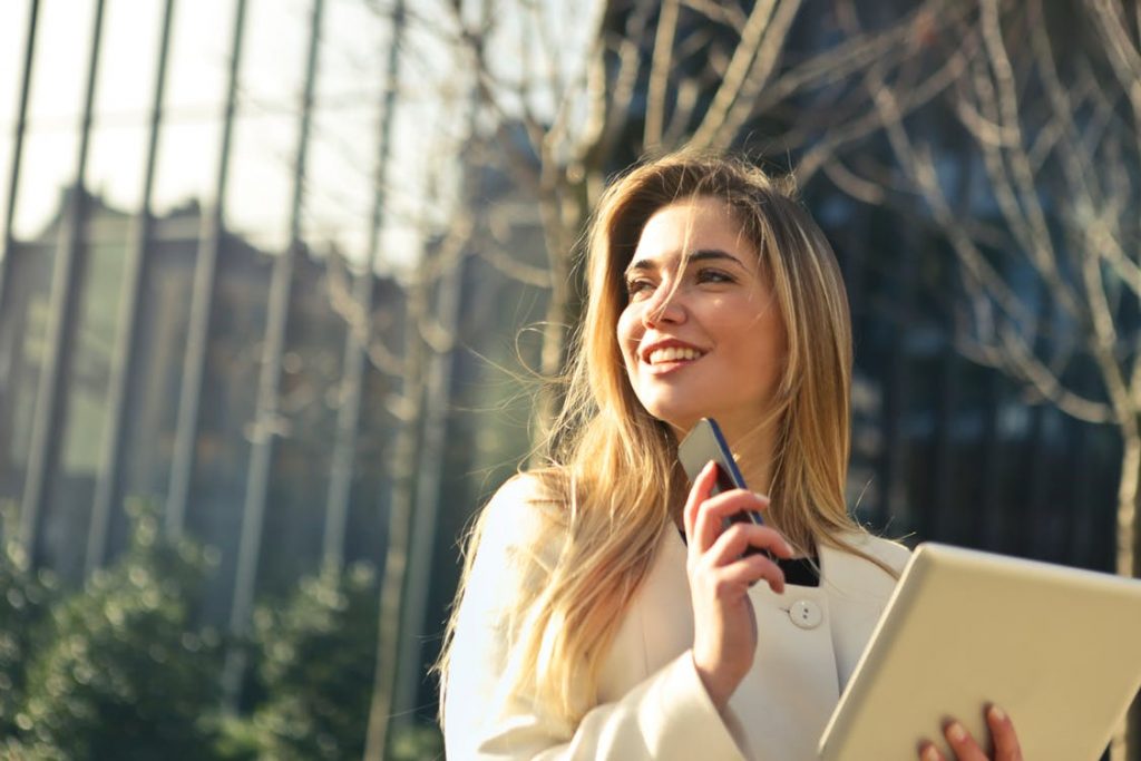 young woman on cell phone and tablet