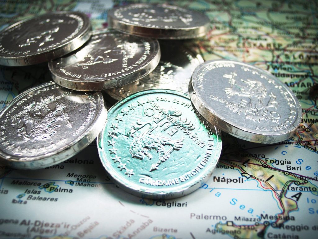 euro coins on top of map