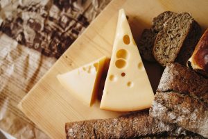 parmesan cheese and bread on cutting board