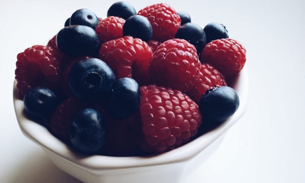 blueberries and raspberries in a small bowl