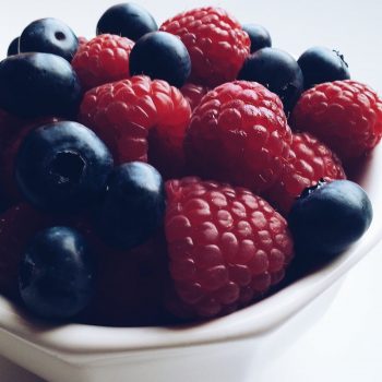 blueberries and raspberries in a small bowl