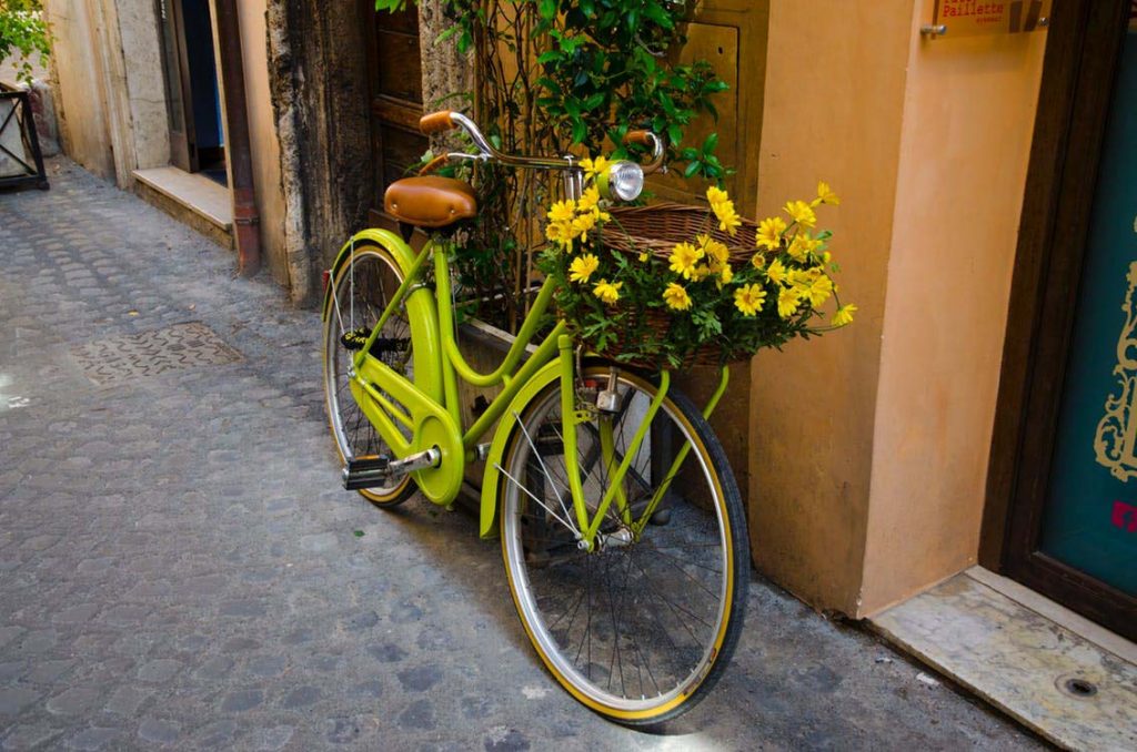 green bike decorated with yellow flowers