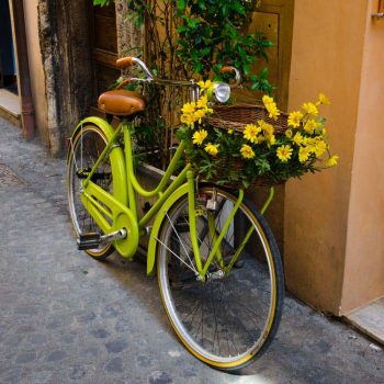 green bike decorated with yellow flowers