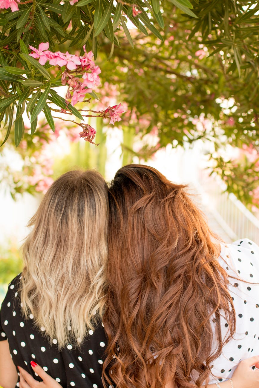 women wearing polkadots hugging