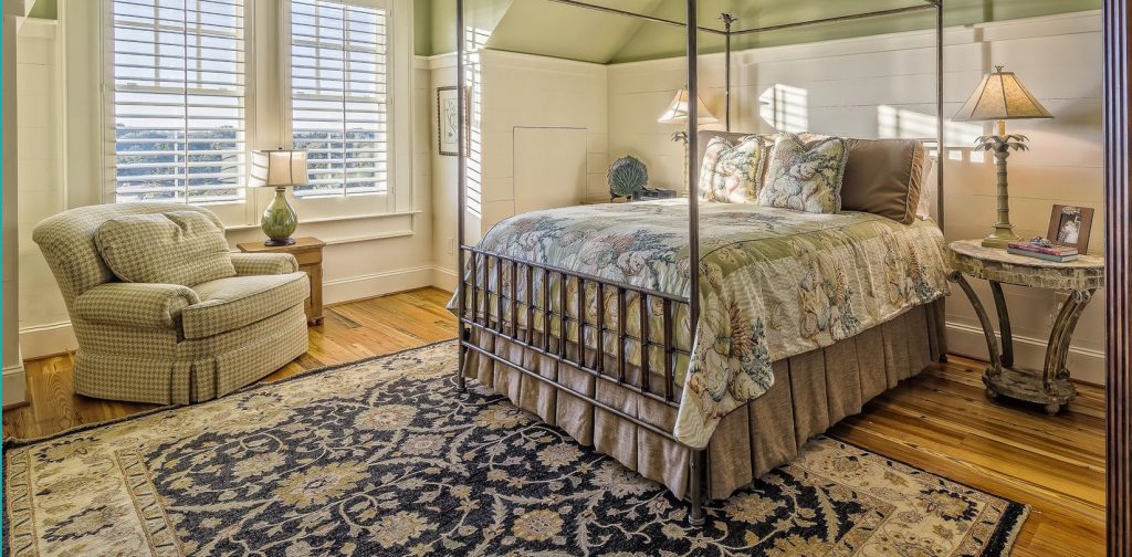 bedroom with hardwood floors and carpet