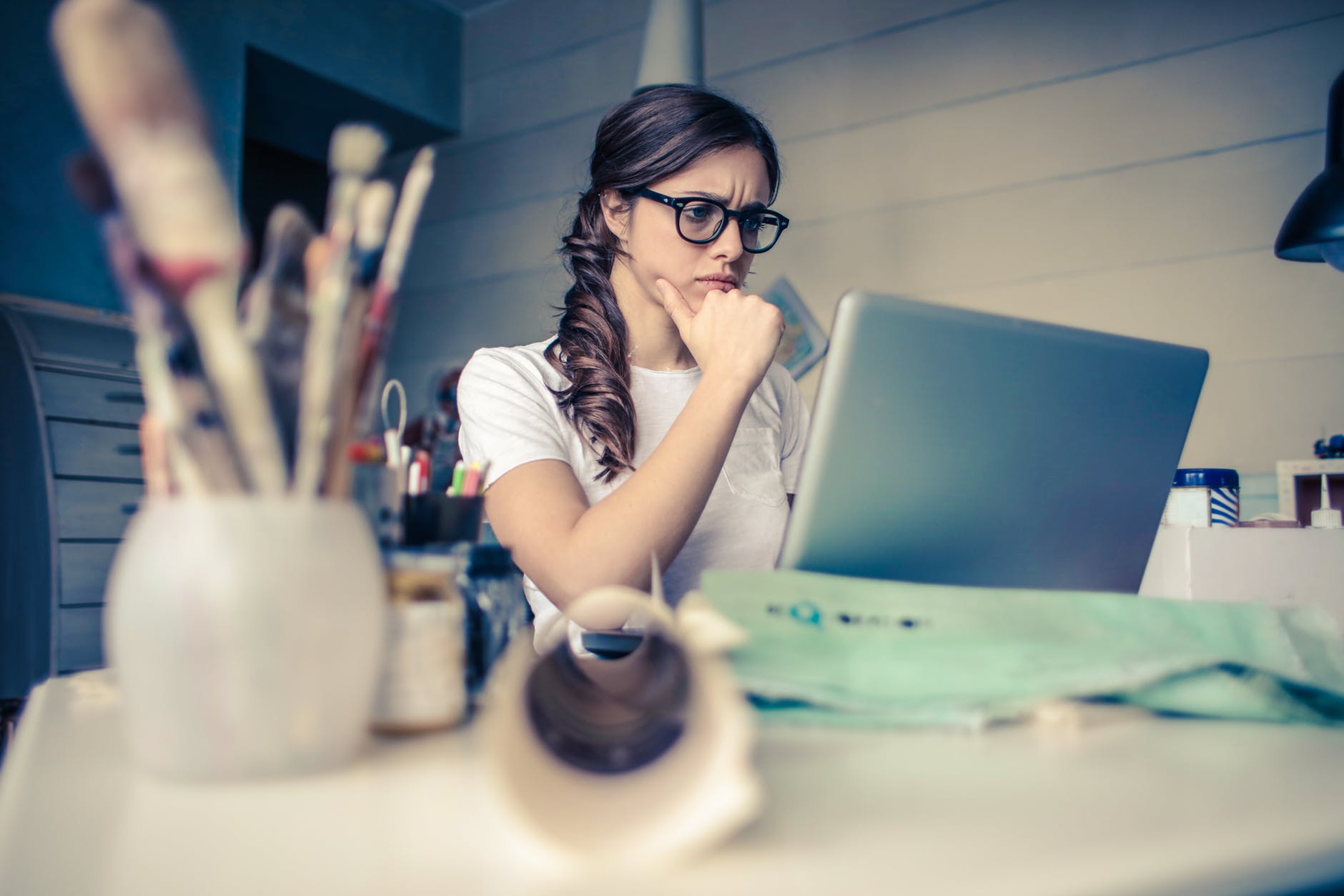 woman looking worriedly at computer screen